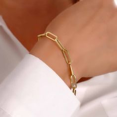 Discover the perfect blend of luxury and comfort with our 14K Solid Gold Paperclip Chain Bracelet. Expertly crafted with semi-hollow links, this exquisite piece combines a lightweight feel with the timeless allure of solid gold. Ideal for both everyday elegance and special occasions, it's a versatile and stylish addition to any jewelry collection. Key Features: Elegant Design: The paperclip chain pattern offers a contemporary twist on a classic style, suitable for any fashion statement. Lightwei Luxury Bracelets With Paperclip Chain, Luxury Gold Chain Paperclip Bracelet As Gift, Luxury Paperclip Bracelet With Solid Link Construction, Luxury Gold Chain Paperclip Bracelet Gift, Luxury Gold Paperclip Chain Bracelet As Gift, Luxury Paperclip Chain Bracelet For Gift, Luxury Paperclip Link Bracelet For Gift, Luxury Tarnish-resistant Chain Link Paperclip Bracelet, Luxury Durable Chain Link Paperclip Bracelet