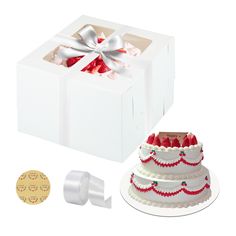 a white box with a cake and ribbon around it