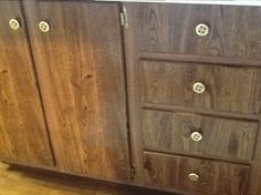 a wooden cabinet sitting on top of a hard wood floor