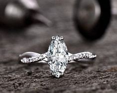 a diamond ring sitting on top of a piece of wood