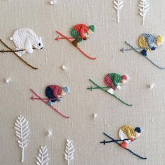 several crocheted mice are on skis and snowflakes in the background