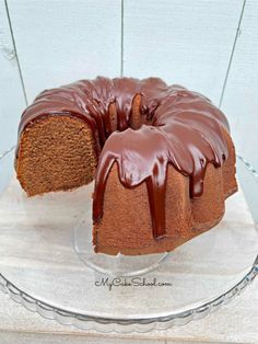 a bundt cake with chocolate icing on a glass plate