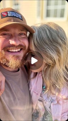 a man and woman are smiling while they pose for a photo with their heads close to each other