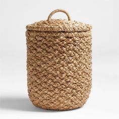 a large woven basket with handles on the top and bottom, sitting in front of a white background