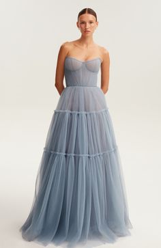 Dreamy dark blue tulle dress with a ruffled maxi skirt. Features a heart-shaped boned bodice with built-in cups, corset back, and a silver belt with Milla’s signature. Includes elegant straps. Material: Tulle Fabric composition: 100% Polyester, 100% Nylon Skirt length from waist: 45.6 inches Dress weight: 2.5 lbs Neckline: Heart-shaped neckline Back: Lacing closure Lining: Cloudy blue full-length flared underskirt Model: 5'8" / 31-23-34, wearing size S Hand wash up to 86ºF Do not bleach Ironing: Dark Blue Tulle Dress, Halloween Crop Top, Blue Tulle Dress, Halloween Skirt, Tulle Maxi Dress, Tulle Maxi Skirt, Dress Weights, Blue Tulle, Corset Back