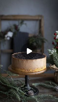 a cake with chocolate frosting and sprinkles sitting on top of a wooden table