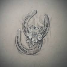 a drawing of a horseshoe with flowers on the side and an antelope's tail