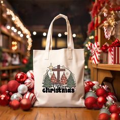 a white bag sitting on top of a wooden table next to christmas ornaments and decorations