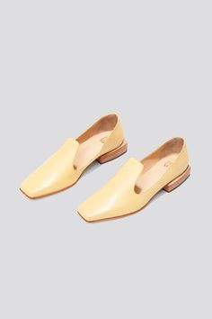 The Olympia Loafer is a babouche-inspired loafer featuring a square boxy toe, a cut-away upper, and a stacked leather heel. Olympia sets itself apart from the typical loafer thanks to its elegant lines. Style the Olympia loafer with suiting for a modern work look or with slip dresses for an elevated, relaxed evening look. Who it’s for: The woman who loves loafers and is looking for a fresh new shape to experiment with. Handmade in Argentina Kidskin leather upper with vegetable tanned leather lin Classic Slip-on Flats With Square Toe, Chic Leather Shoes With Removable Insole And Square Toe, Classic Square Toe Flats With Leather Sole, Formal Slip-on Loafers With Sculpted Heel, Formal Square Toe Loafers For Spring, Chic Slip-on Loafers With Square Toe, Modern Loafers With Stacked Heel For Spring, Chic Slip-on Loafers With Sculpted Heel, Leather Slip-on Loafers With Sculpted Heel