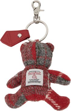 a red and gray teddy bear keychain with a tag on it's side