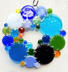 a multicolored glass beaded necklace on a hook