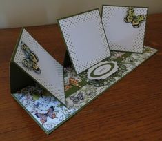 an open card with butterflies on it sitting on a table