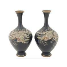 two black vases with gold dragon designs on the sides, one has a white background