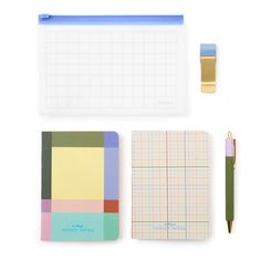 various stationery items including notebooks, pens and pencils on a white surface