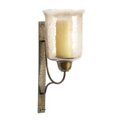 an old fashioned wall light with a candle on it's side and a ruler in front of it