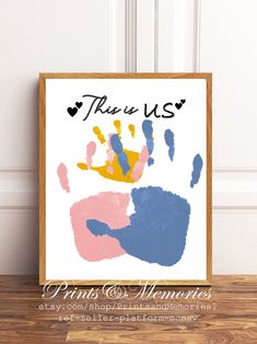 a framed print with the words true us and handprints