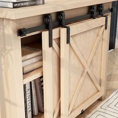 a kitchen island with sliding doors and books on the shelf next to it in a living room