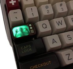 a computer keyboard with a green light on it's keypad and the words caps lock checkout