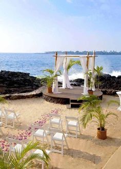 an outdoor wedding set up on the beach