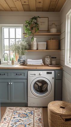 a washer and dryer in a small room with wood flooring on the walls