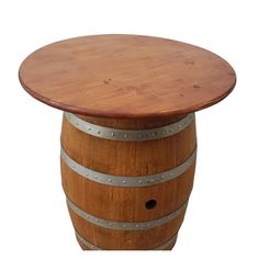 a wooden barrel table with metal straps around it and a round top on an isolated white background