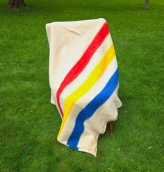 a blanket on a chair in the grass