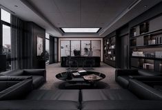 a living room filled with black furniture and lots of windows