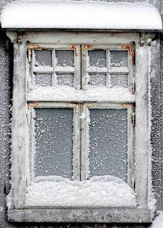 an old window is covered in snow