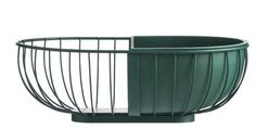 a large green metal basket sitting on top of a table