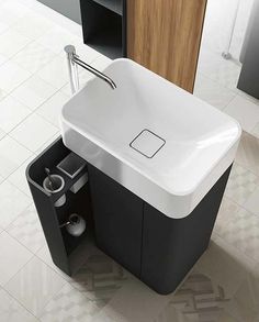 a bathroom sink sitting on top of a tiled floor