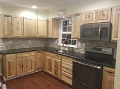 a kitchen with wooden cabinets and black appliances