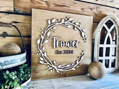 a wooden sign that says tower est 2012 on it next to some potted plants