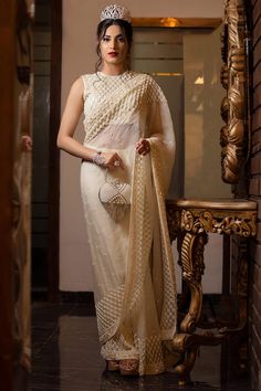 Ivory sequin and bead embroidered saree. Paired with an all over embroidered checkered pattern padded blouse and petticoat. - Aza Fashions Elegant Off White Pre-draped Saree For Festive, Festive Cream Georgette Pre-draped Saree, Elegant Pre-draped Saree With Chikankari For Festive Occasions, Elegant Chinon Blouse Piece For Reception, Designer Cream Pre-draped Saree With Zari Work, Off White Designer Pre-draped Saree For Festive Occasions, Elegant Off White Pre-draped Saree With Resham Embroidery, Elegant Chikankari Pre-draped Saree For Reception, Festive Designer Cream Pre-draped Saree