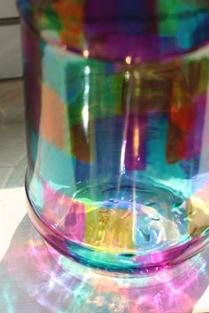 a colorful glass vase sitting on top of a table