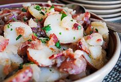 a bowl filled with shrimp and potatoes on top of a table