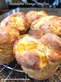 several muffins cooling on a wire rack with the words mandarin orange muffins