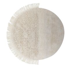 a round rug with fringes on the bottom and an oval rug in the middle