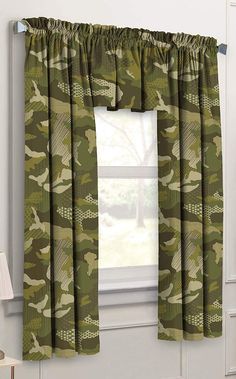 a window with a green camouflage curtain and matching valance in front of the window