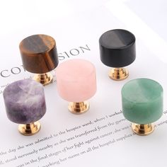 four different colored knobs sitting on top of a piece of paper