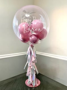 some balloons are in the shape of a pig on top of a stand with streamers