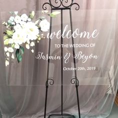 a wedding welcome sign with flowers on it