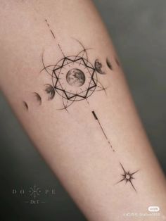 a woman's arm with tattoos on it and the moon in the center, surrounded by stars