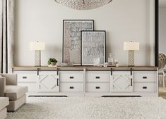 a living room with white furniture and a chandelier