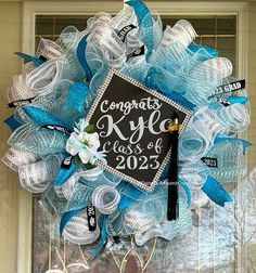 It's that time of year for graduation. How about a custom, made to order wreath for your front door or graduation party. Made with your color choice mesh, ribbon and highlighted with a blinged out graduation cap with a tassel. Customize your wording on the cap.  These wreaths are made to order, if your interested in doing a split color wreath i.e high school and college of choice feel free to send me a message or add to the note section.  Add your wording in the note section pictures are from previous years, your wreath will show the current year Money Wreath, Graduation Wreath, Front Door Swag, Fall Swags, Butterflies Wreath, Purple Wreath, Pink Wreath, Mesh Ribbon, Wreath Front Door