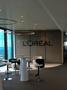 an office with chairs and tables in front of a large window that reads'dropal '