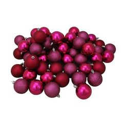 a pile of red christmas balls sitting on top of each other