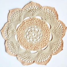 crocheted doily on white surface with circular design