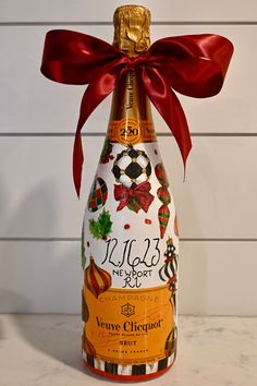 a bottle of wine with a red bow on it