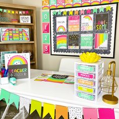 a classroom desk with lots of colorful papers on it and a chalkboard in the background