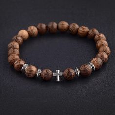 Description: This beautiful, beaded faith bracelet is the perfect reminder of faith. It can be worn solo or mix-and-matched with bracelets of other styles. It is the perfect gift for a friend, significant other, or loved one! Made with wooden beads, silver alloy, and elastic string. Easily put on and taken off Multiple sizes available Stretchy and fits most sizes Please double check your wrist size before ordering - fits true to size - thank you! Sizes: 6 in., 7.5 in., or Customized Shipping: Sh Mens Vintage Jewelry, Cross Bracelets, Prayer Bead Bracelet, Compass Bracelet, Shark Earrings, Meditation Prayer, Wood Bead Bracelet, Viking Bracelet, Surfer Necklace